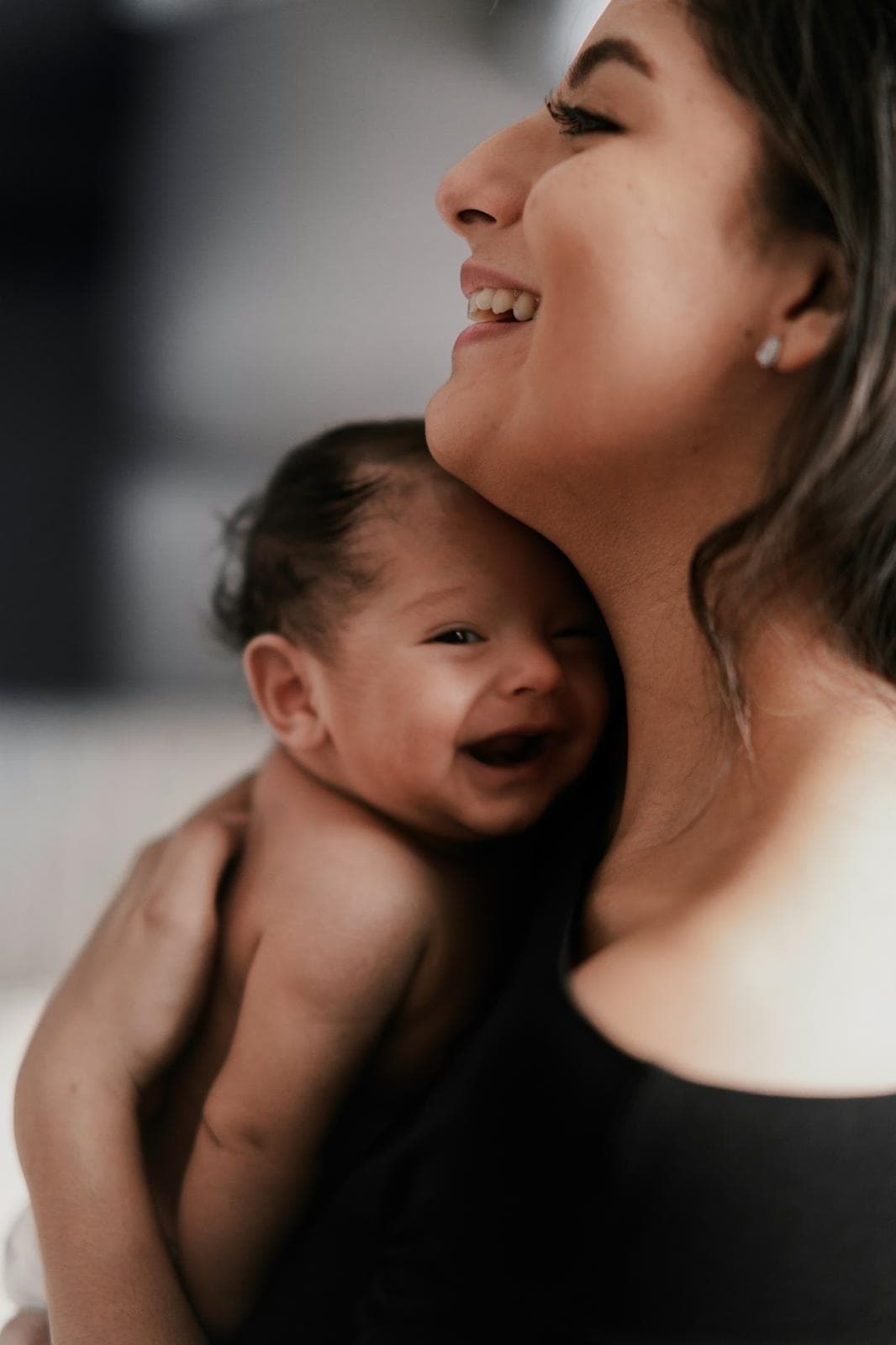 A mother holding her newborn cheek to cheek