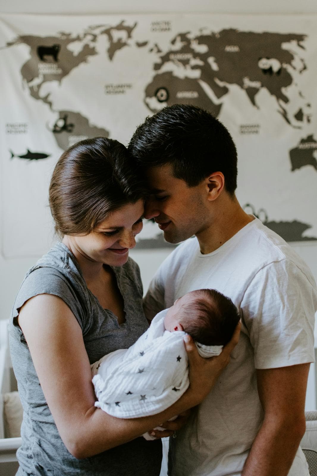 New parents cradling their baby